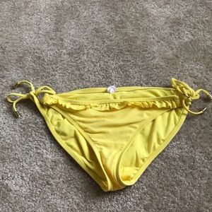 Yellow bathing suit bottoms with ruffle on front